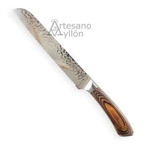 Cuchillo 3 Claveles Sakura Pan 19 cm con hoja larga de acero inoxidable acabado martilleado y filo ondulado dentado para pan, acompañado de mango ergonómico de madera Pakka con vetas marrones sobre fondo blanco.